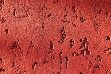 Texture, background rough plaster covered with red paint 