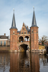 Fototapeta na wymiar View of the historic Waterport gate with water reflection in a Dutch town of Sneek