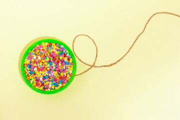 Balloon with sweets confetti on a string. Copy space