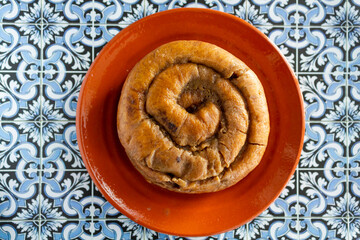 Top view of portuguese easter cake called Folar Algarvio de Olhao on portuguese tiles background