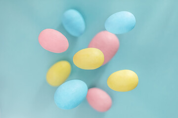 Easter background. Levitating Easter eggs in pastel colors on a blue background. composition of an Easter greeting card, pattern.