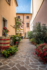 Fototapeta na wymiar A picturesque street of Bardolino, a town on Lake Garda. Veneto, Italy