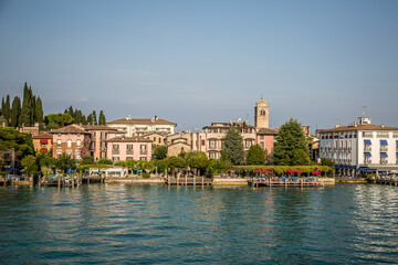 Fototapeta na wymiar Sirmione. View of the marina and the town on Lake Gardaa. Lombardy, Italy