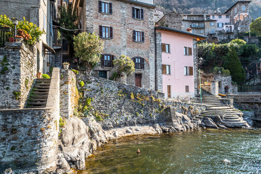 The village of Corenno Plinio with stone houses overlooking a small port