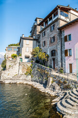 The village of Corenno Plinio with stone houses overlooking a small port