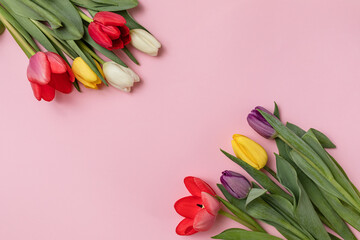 spring colored tulips on a delicate pink background. with space for the text. a greeting card, an invitation to a holiday.