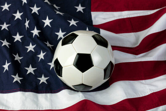 Leather soccer ball with American flag in background