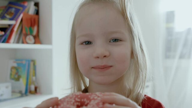 child eating donut at home. kids love donuts