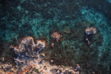 Naklejka na ściany i meble A stretch of coast with turquoise sea, transparent water that allows you to see the seabed.