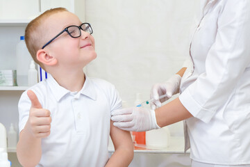 Little boy receiving vaccination at the clinic, close up.