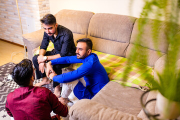 friends from india talking in living room and have fun