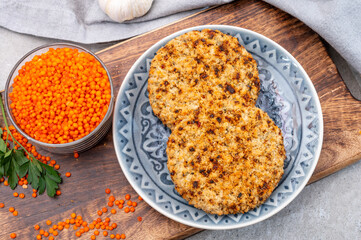 Healthy vegetarian or vegan food, meat free burger made from orange lentils legumes