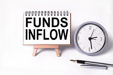 FUNDS INFLOW. Text on white notepad paper on light background