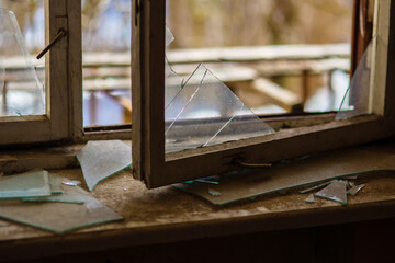 Broken window. Broken glass, spider web. Concept: devastation, time, poverty.