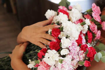 Woman holding a beautiful colourful blossoming flower bouquet