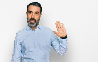 Fototapeta premium Middle aged man with beard wearing business shirt waiving saying hello happy and smiling, friendly welcome gesture