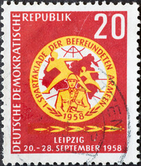 GERMANY, DDR - CIRCA 1958 : a postage stamp from Germany, GDR showing the emblem of the Spartakiad. Summer Partakiade of the friendly armies in Leipzig