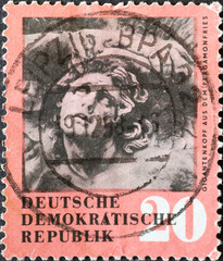 GERMANY, DDR - CIRCA 1958 : a postage stamp from Germany, GDR showing a giant head from the frieze of the Pergamon Altar in Berlin