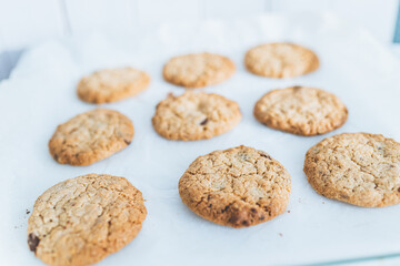 Oatmeal broun homemade cookies on white table. Healhy desserts, diet