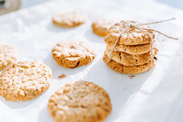 Oatmeal broun homemade cookies on white table. Healhy desserts, diet