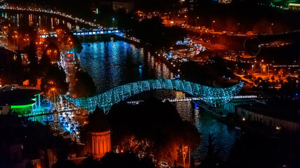 Night Illumination of Tbilisi city, Nice view of the Bridge of Peace. Georgia.