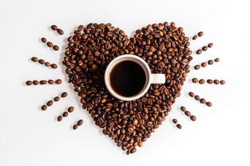Show your love with a coffee. A cup inside a beating heart made of coffee beans on a white background.