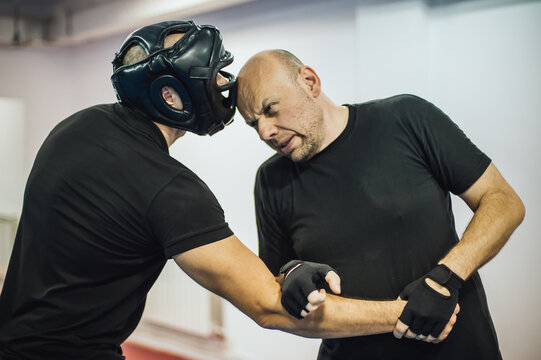 Instructor demonstrate headbutt street fight technique against attacker. Head kick