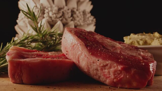 Seasoning the meat, raw Barbecue Rib Eye Steak