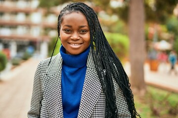 Young african american businesswoman smiling happy standing at the park.