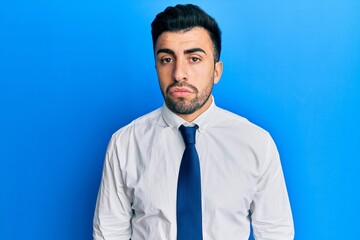 Young hispanic man wearing business clothes depressed and worry for distress, crying angry and afraid. sad expression.