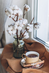 a cup of coffee and macaroon cake