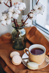 a cup of coffee and macaroon cake
