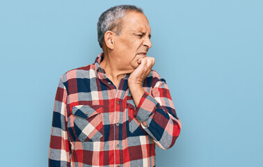 Senior hispanic man wearing casual clothes looking stressed and nervous with hands on mouth biting nails. anxiety problem.