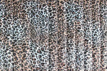 Fashionable leopard-print quilted fabric. Abstract background with leopard pattern .Horizontal orientation