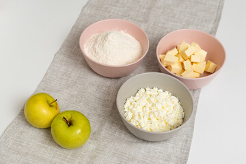 Fototapeta na wymiar Main ingredients for Apple Pie. Flour, butter, cottage cheese and apples.