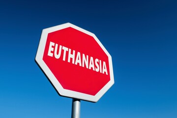 Stop sign with EUTHANASIA test to protest against voluntary suicide in case of suffering
