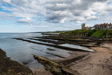 Cityscape of Saint Andrews city with St Rules Tower, ruins, and coastline
