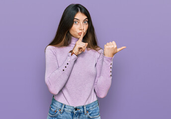 Fototapeta premium Young beautiful teen girl wearing turtleneck sweater asking to be quiet with finger on lips pointing with hand to the side. silence and secret concept.