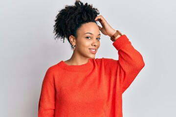 Young african american girl wearing casual clothes smiling confident touching hair with hand up...
