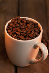white cup of coffee beans 