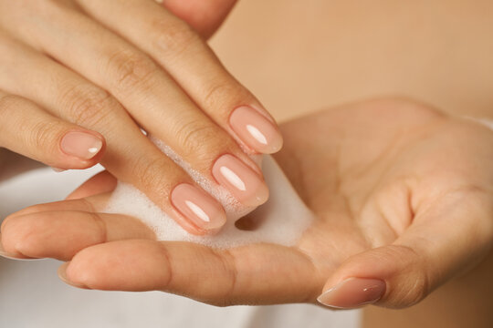 Close Up Of Female Hands Holding, Applying Gentle Foam Facial Cleanser