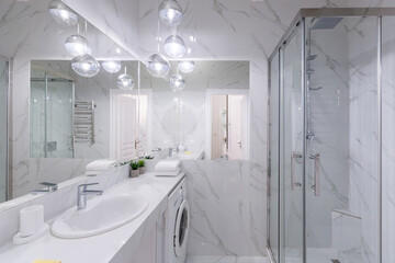 Bathroom interior with white marble tiles and modern style shower