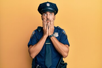 Handsome hispanic man wearing police uniform tired hands covering face, depression and sadness, upset and irritated for problem