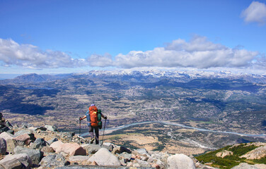 A trekker with a beautiful view of Rio Ibanez and Villa Cerro Castillo, Aysen, Patagonia, Chile