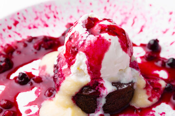 Photo of delicious tasty ice cream with berries and brownie