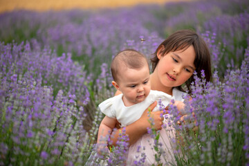 Family portrait in lavender field, two sisters together having fun