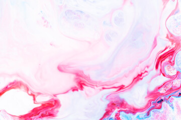 Obraz premium Fluid art. Abstract colorful background, wallpaper. Liquid marbling background. Mixed blue and light pink paints. Trendy colorful backdrop