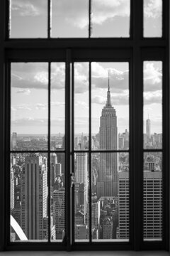 Fototapeta Empire State Building in Midtown Manhattan seen through a window