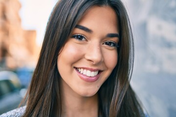 Young beautiful hispanic girl smiling happy walking at the city.