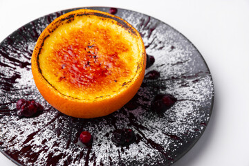 Tasty creme brulee in a orange on plate